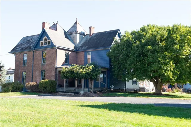 a front view of a house with a yard
