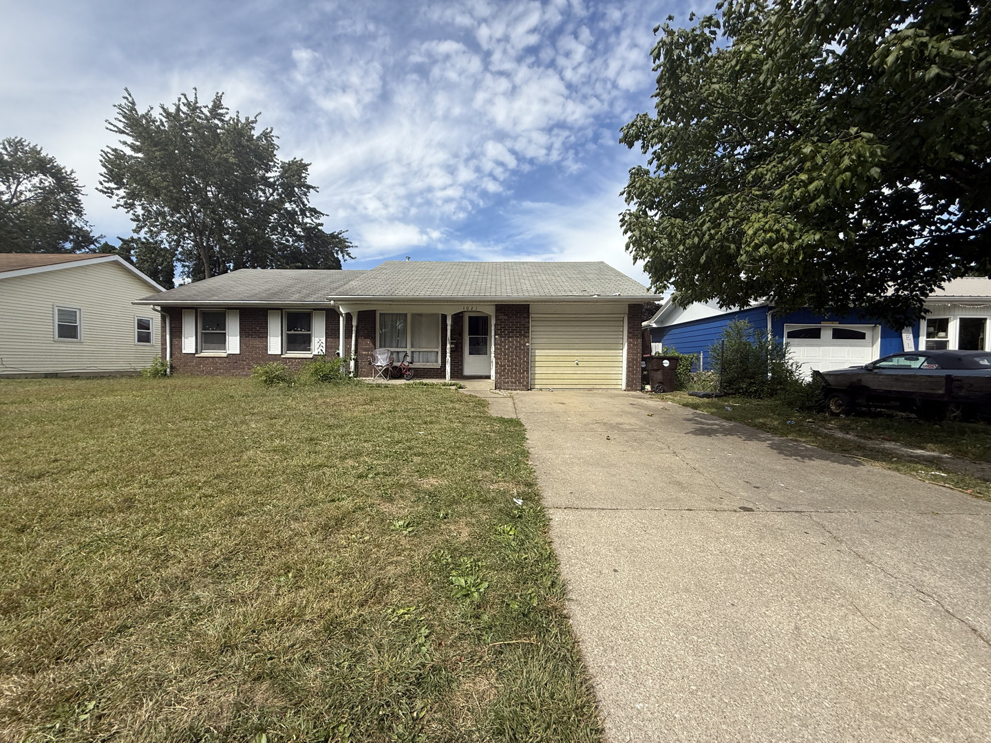 1021 Briarcliff Drive Rantoul, IL 61866 - Photo 1 of 33 a front view of a house with a garden and trees
