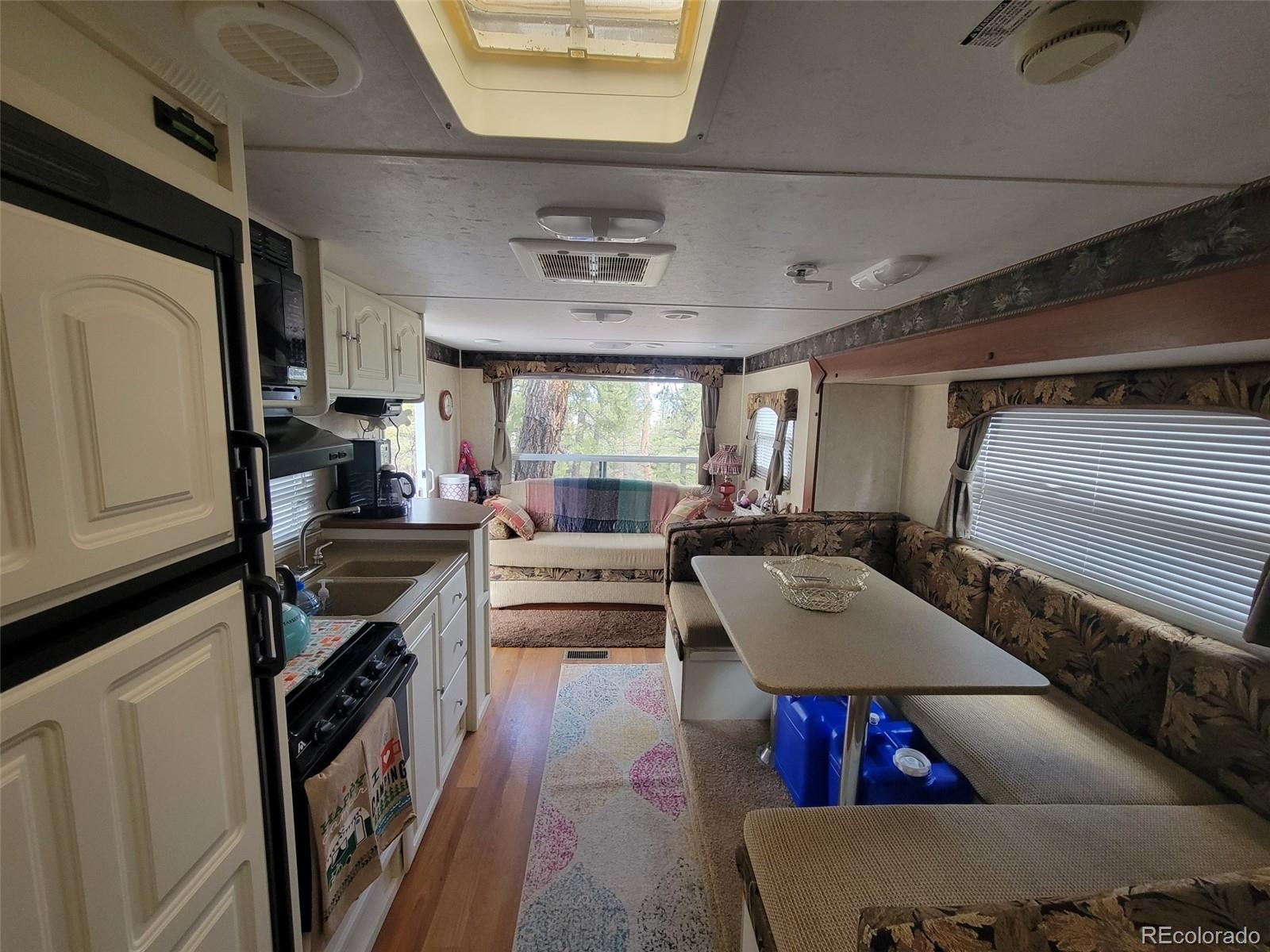 94 Pullman Loop Fairplay, CO 80440 - Photo 15 of 21 a living room with furniture and a flat screen tv