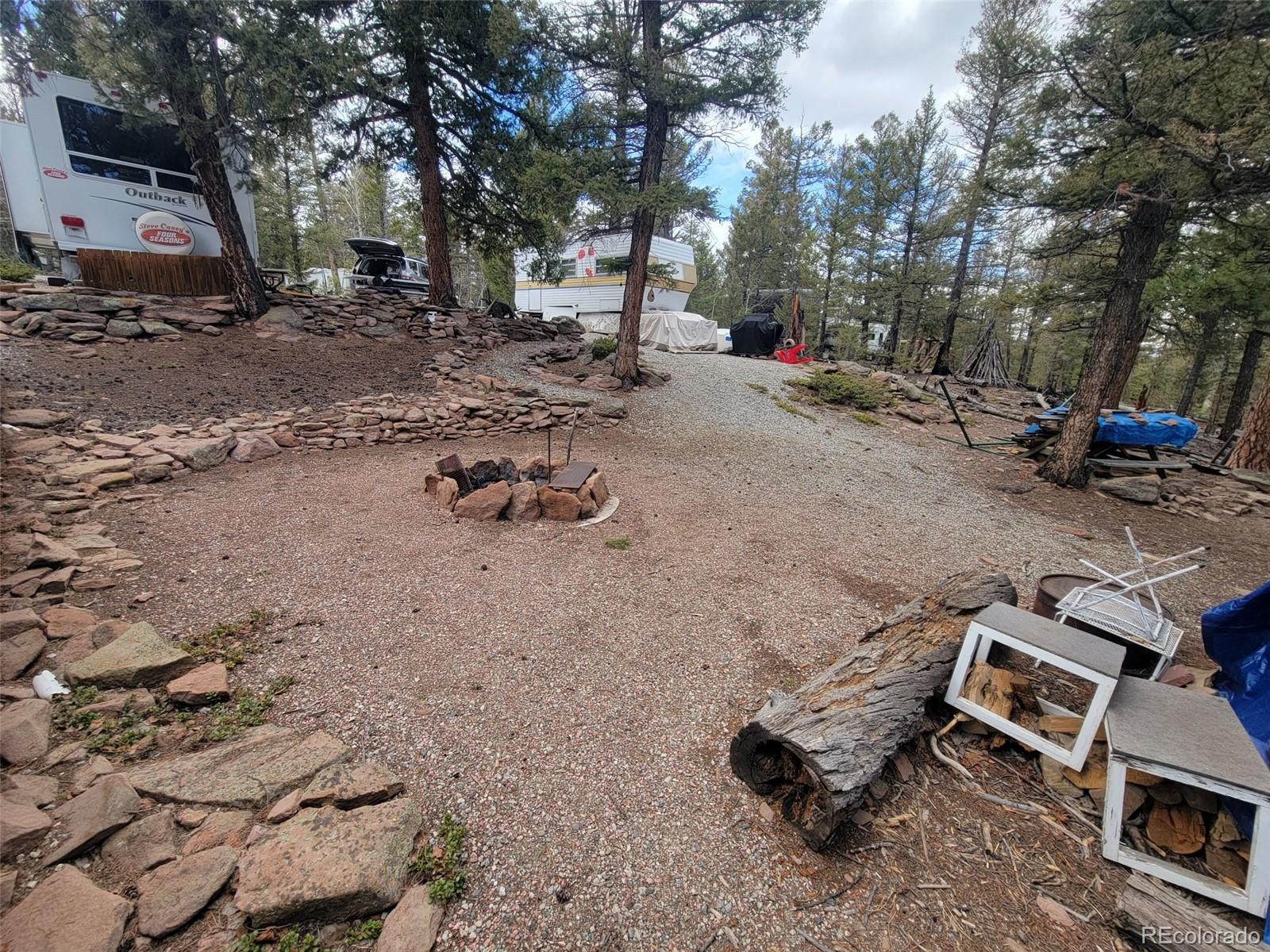 94 Pullman Loop Fairplay, CO 80440 - Photo 3 of 21 a backyard of a house with fire pit and outdoor seating