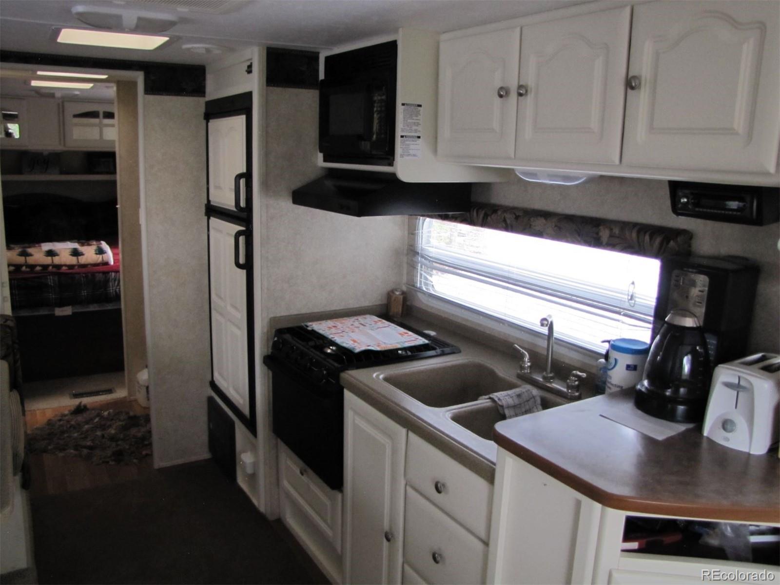 94 Pullman Loop Fairplay, CO 80440 - Photo 8 of 21 a kitchen with stainless steel appliances a sink stove and refrigerator