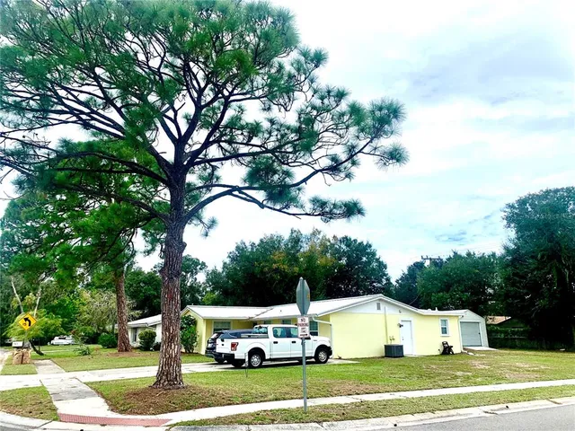 a car parked in front of house with a yard