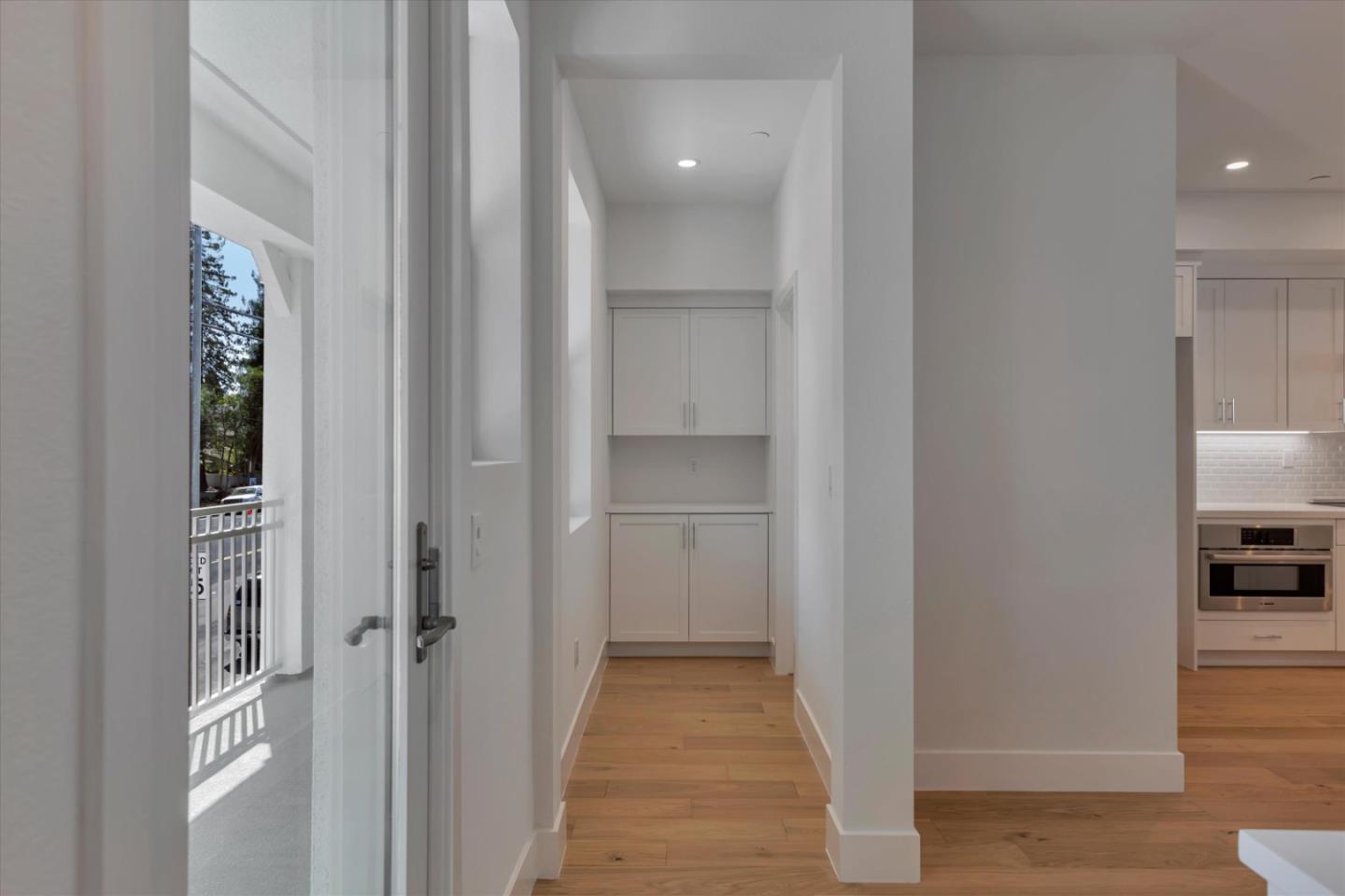 2741 Oak Road Walnut Creek, CA 94597 - Photo 11 of 20 a view of a hallway with wooden floor and a living room