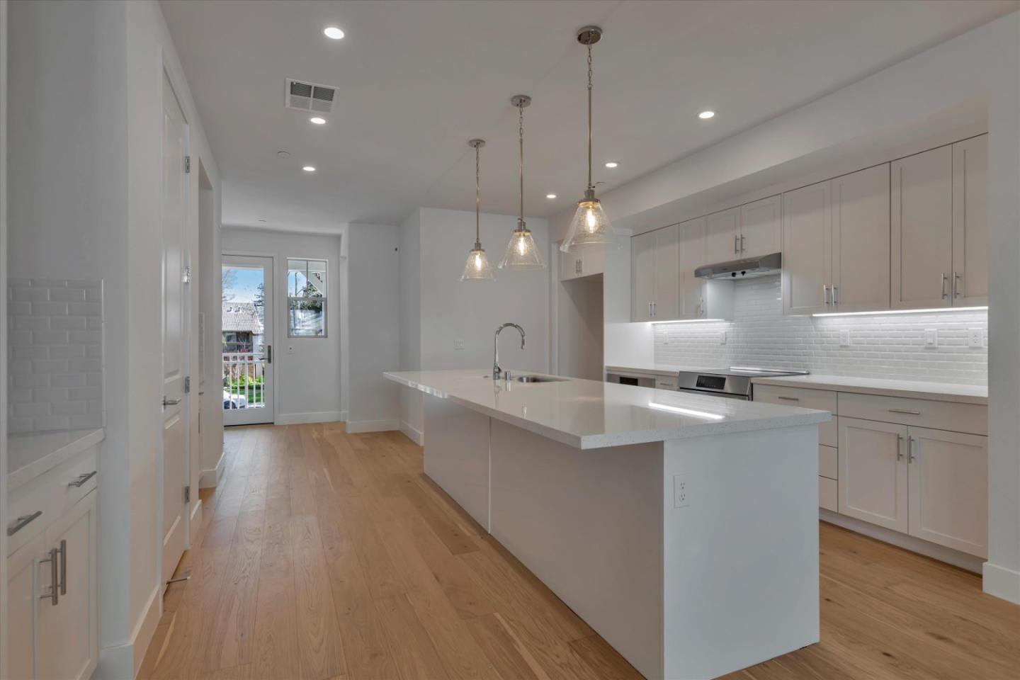 2741 Oak Road Walnut Creek, CA 94597 - Photo 9 of 20 a large kitchen with kitchen island a sink stainless steel appliances and white cabinets
