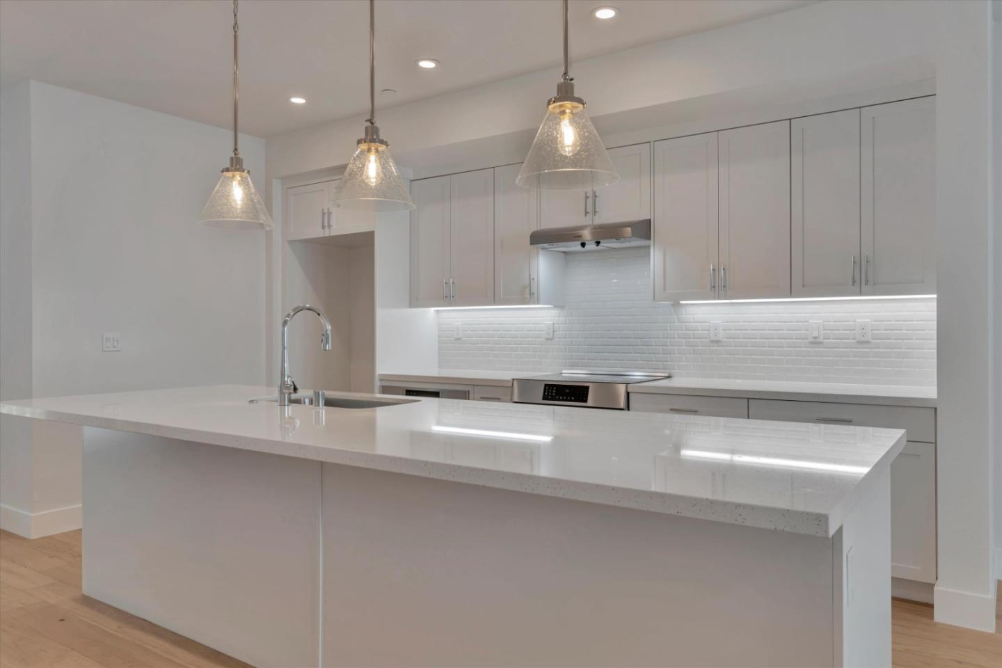 2741 Oak Road Walnut Creek, CA 94597 - Photo 10 of 20 a large kitchen with a sink and chandelier