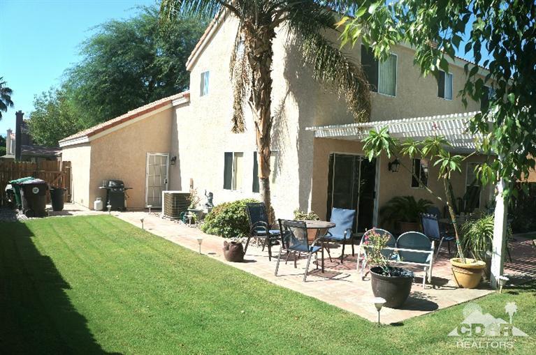 80928 Rio Grande Avenue Indio, CA 92201 - Photo 23 of 25 a view of a chair and tables in the backyard of the house