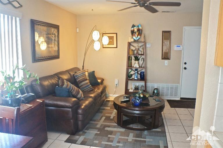 80928 Rio Grande Avenue Indio, CA 92201 - Photo 3 of 25 a living room with furniture and a mirror