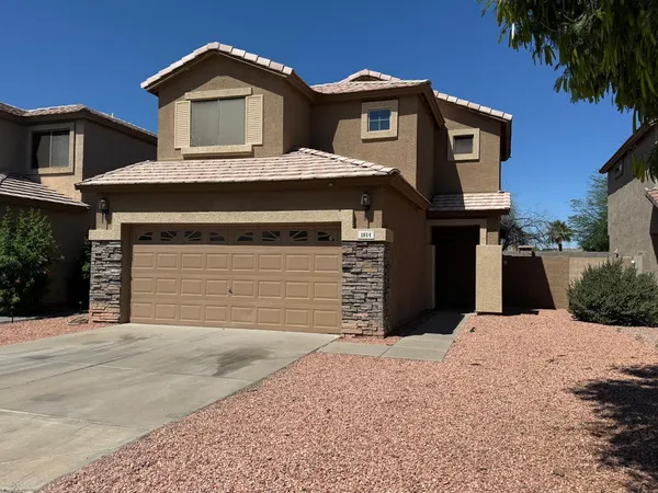 a front view of a house with a garage