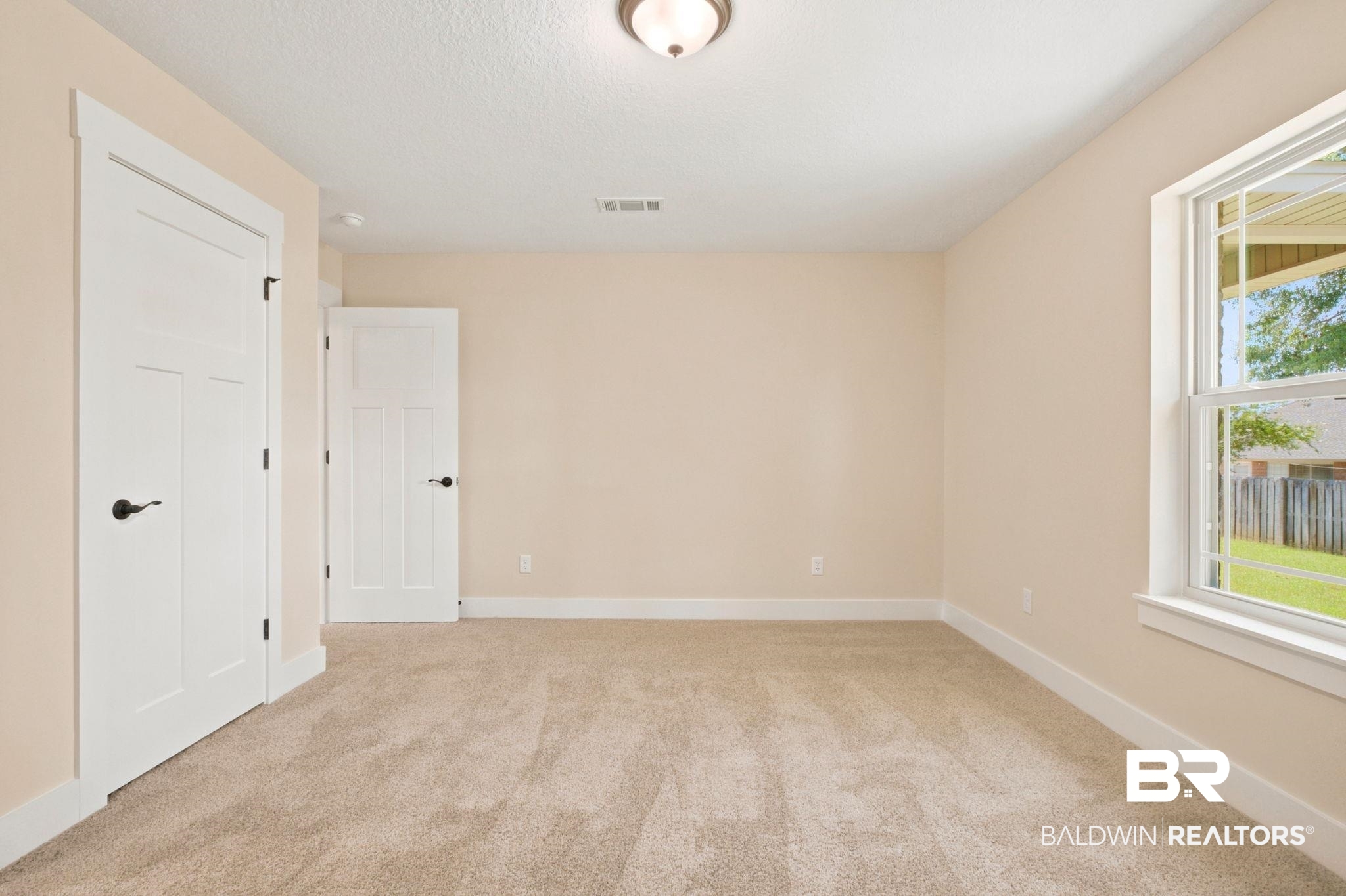 32656 Arbor Ridge Circle Lillian, AL 36549 - Photo 28 of 56 Neutral-toned carpeting and walls complement the bright white trim and solid core doors with matte black hardware