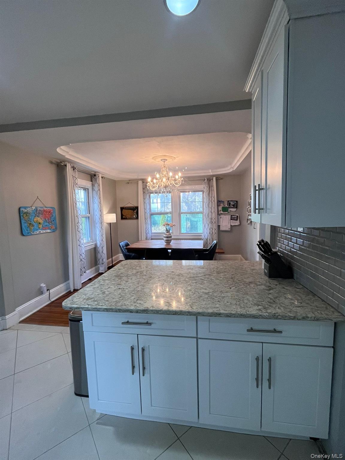 14 Redbrook Road Great Neck, NY 11024 - Photo 4 of 20 a kitchen with kitchen island granite countertop a sink window and refrigerator