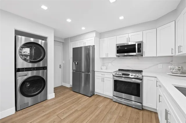 a kitchen with a stove top oven a refrigerator and cabinets