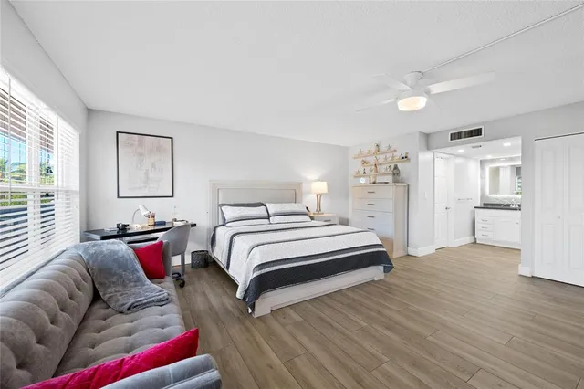 a bedroom with a bed and wooden floor