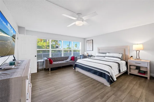 a bed room with a bed and a large window