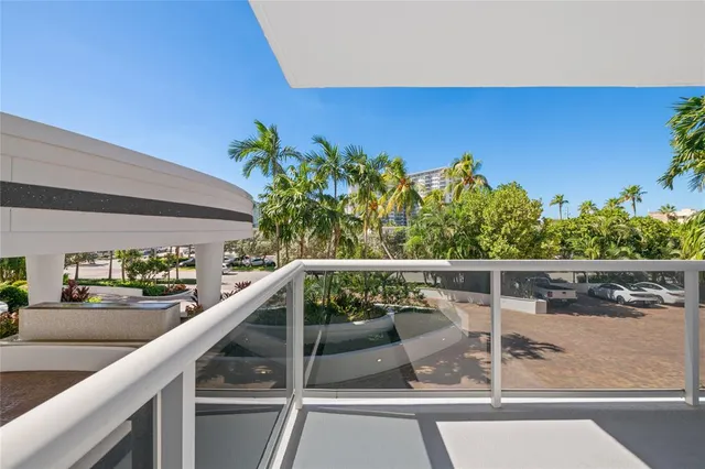 a view of balcony with wooden floor and seating space