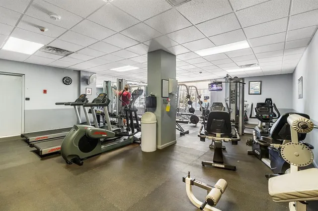 a room with pool table and windows