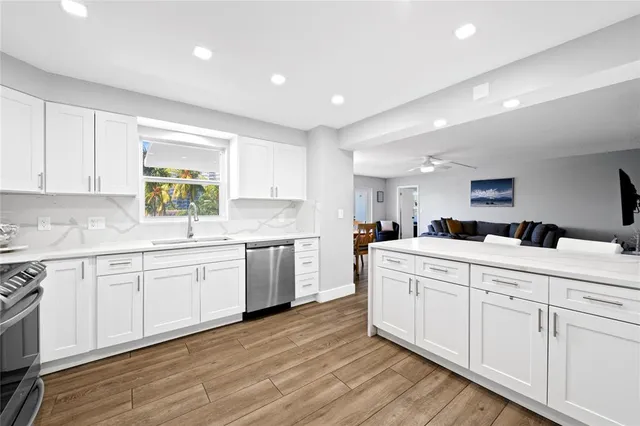a kitchen with sink stove and cabinets