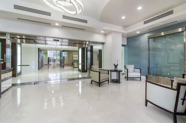 a large hall with stainless steel appliances a large counter top