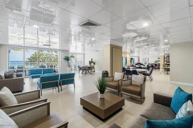 a living room with furniture and a glass door