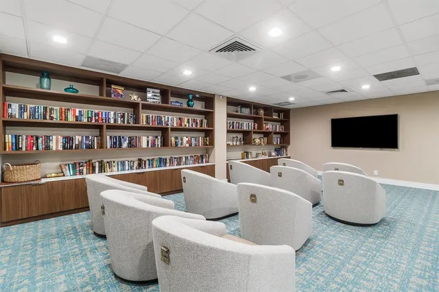 a view of a hallway with seating area