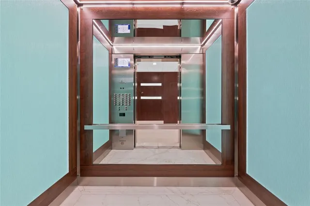 a front view of a multi story building with yard