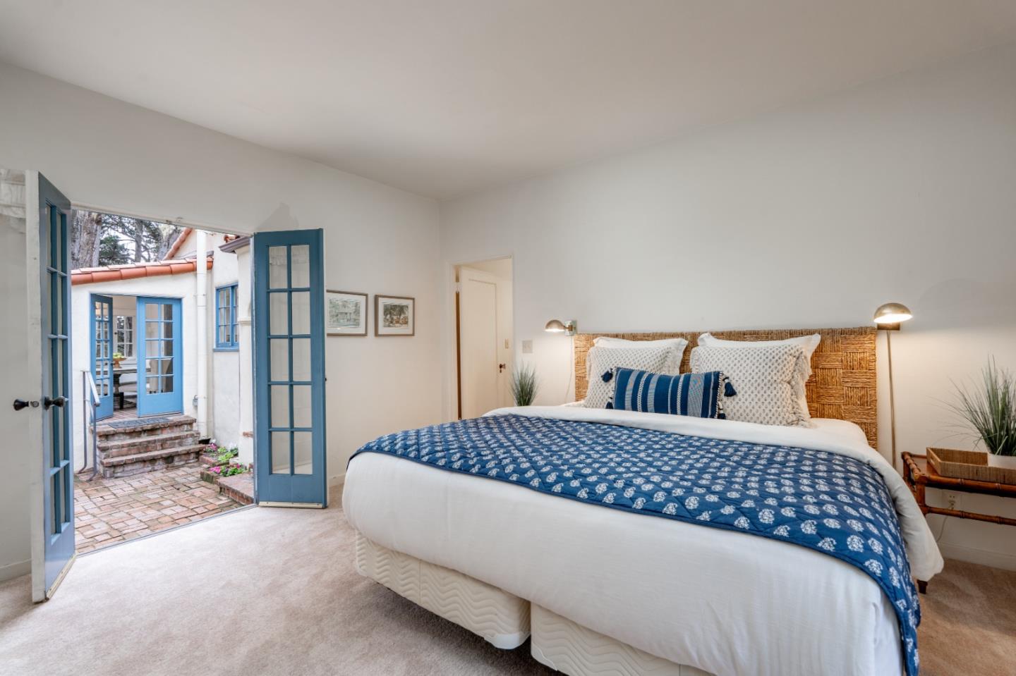 161 Spindrift Road Carmel, CA 93923 - Photo 15 of 20 a bedroom with a large bed and a large mirror