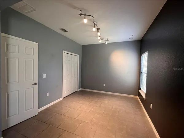 en empty room with windows and closet