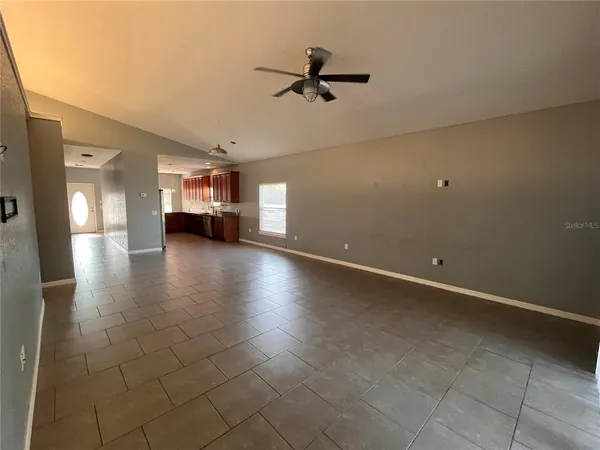 an empty room with a empty space and windows