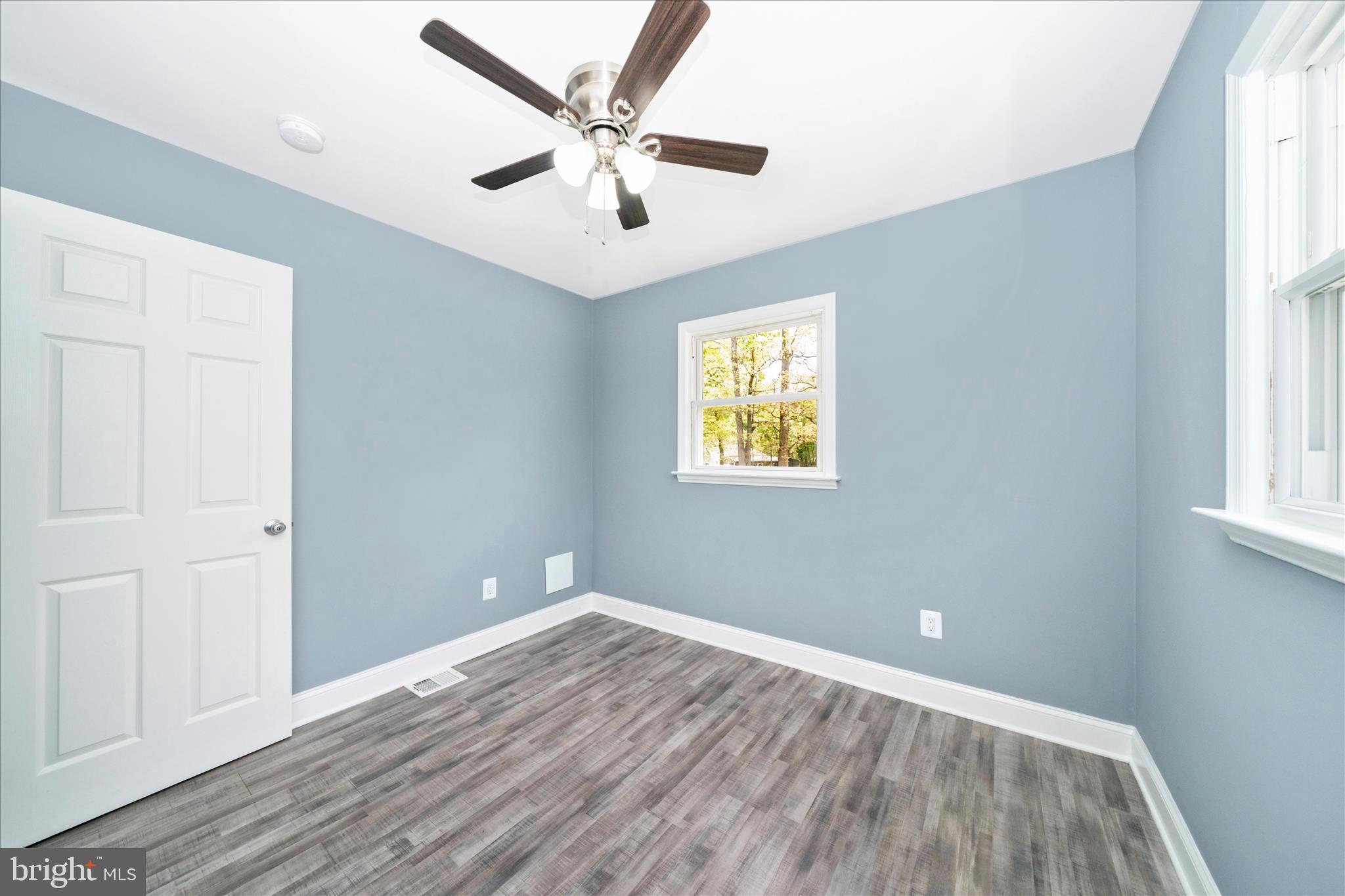 6737 Allentown Road Temple Hills, MD 20748 - Photo 37 of 51 wooden floor in an empty room with a window