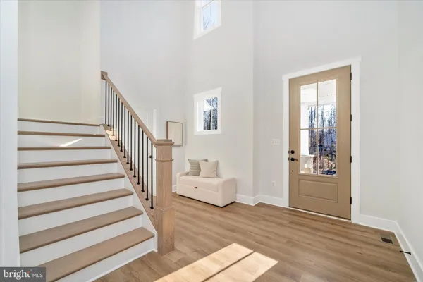 a view of an entryway with wooden floor and windows