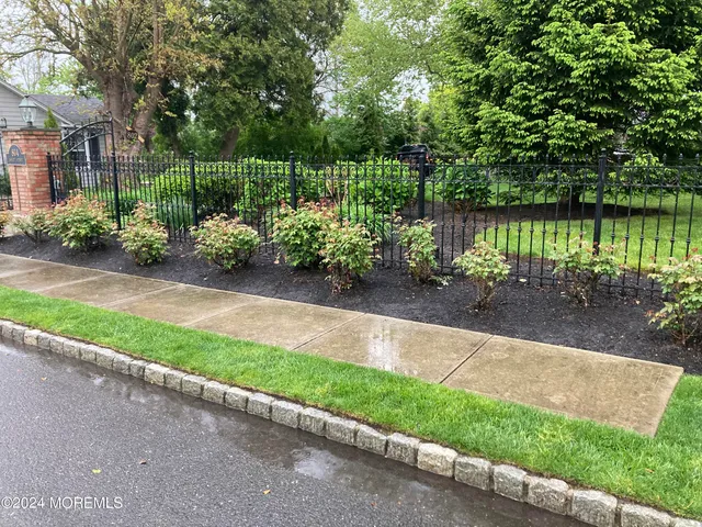 a garden with trees in the background