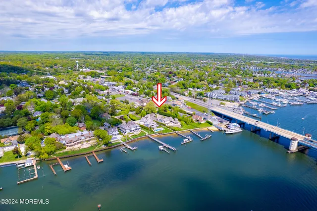 an aerial view of residential houses with outdoor space and trees