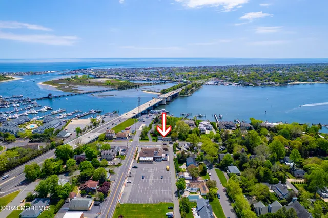 an aerial view of a houses with a lake view