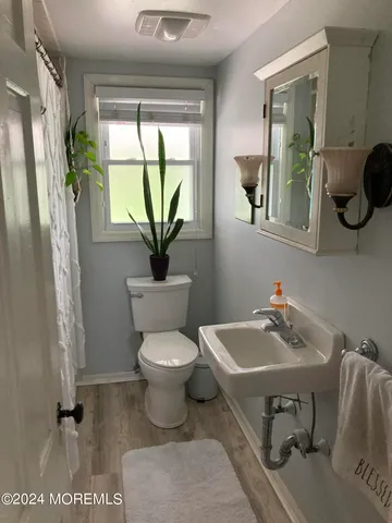 a bathroom with a sink toilet and mirror