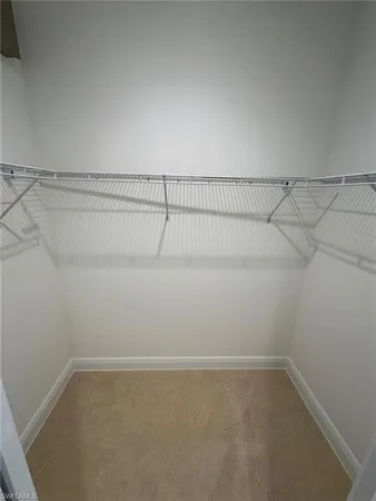 a view of a hallway to a livingroom with furniture