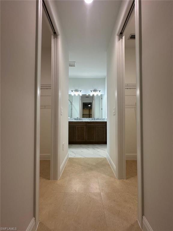 2167 Della Drive Naples, FL 34117 - Photo 12 of 17 a view of a hallway to a livingroom with furniture