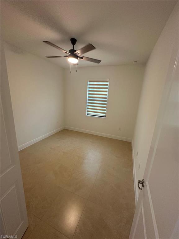 2167 Della Drive Naples, FL 34117 - Photo 14 of 17 an empty room with windows and fan