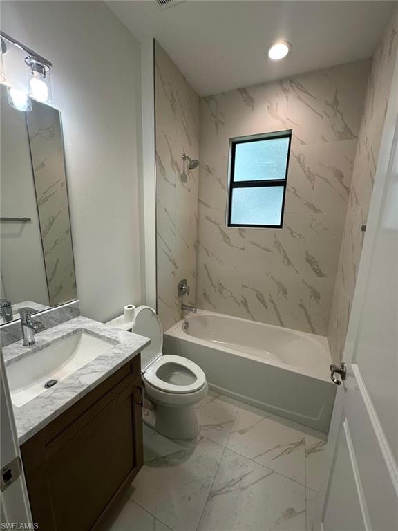 2167 Della Drive Naples, FL 34117 - Photo 15 of 17 a bathroom with a sink a toilet and bathtub