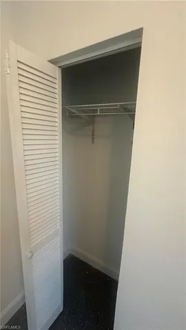 a utility room with cabinets and dust bin