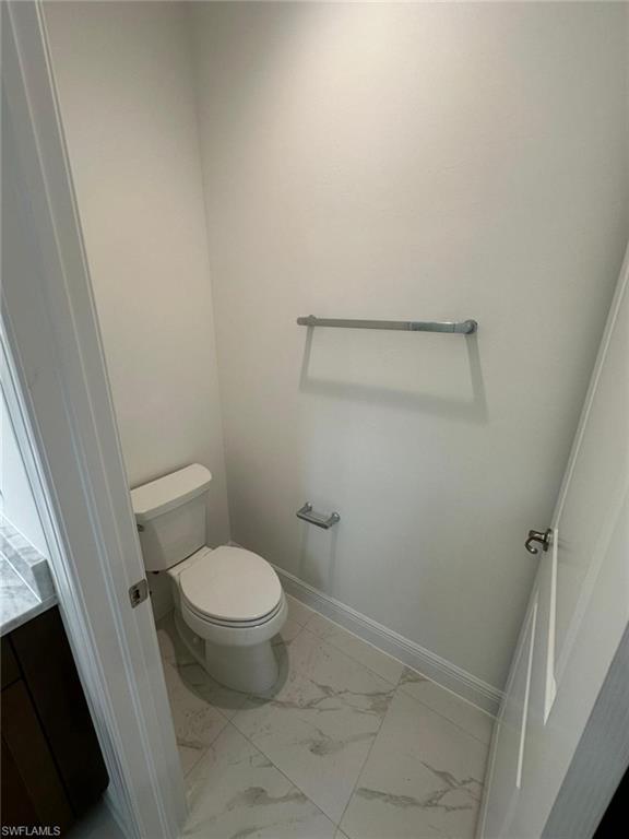 2167 Della Drive Naples, FL 34117 - Photo 7 of 17 a white toilet sitting next to a shower