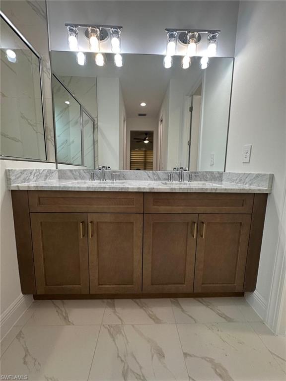 2167 Della Drive Naples, FL 34117 - Photo 9 of 17 a bathroom with a sink and a mirror