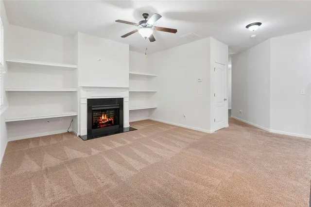 a view of an empty room with a fireplace