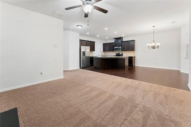 a large room with a kitchen and a sink