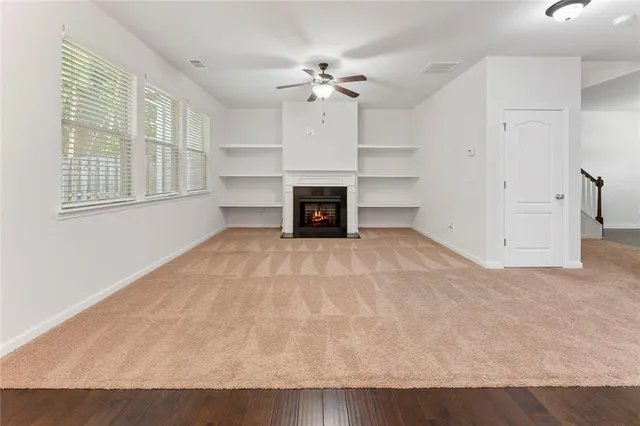 wooden floor fireplace and windows in a room