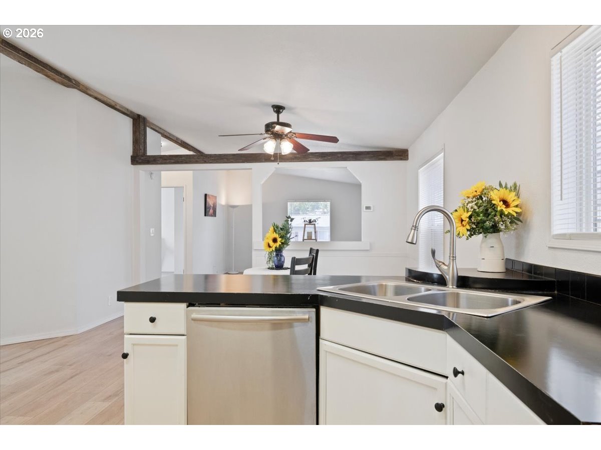 365 Southwest 7th Avenue Mill City, OR 97360 - Photo 13 of 43 a kitchen with kitchen island a sink and a chandelier