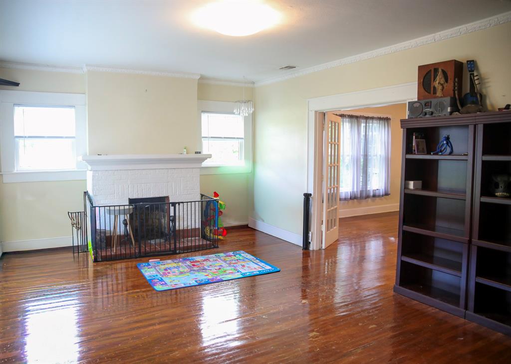 1500 Bonham Street Commerce, TX 75428 - Photo 3 of 29 a living room with furniture and a wooden floor