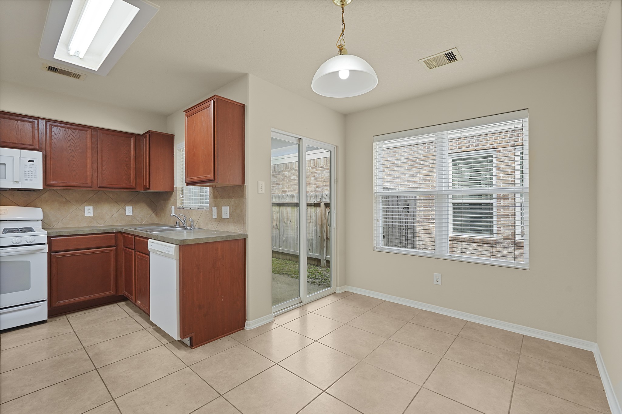 29417 Forest Floor Lane Spring, TX 77386 - Photo 11 of 25 a kitchen with stainless steel appliances granite countertop a stove a sink and a refrigerator