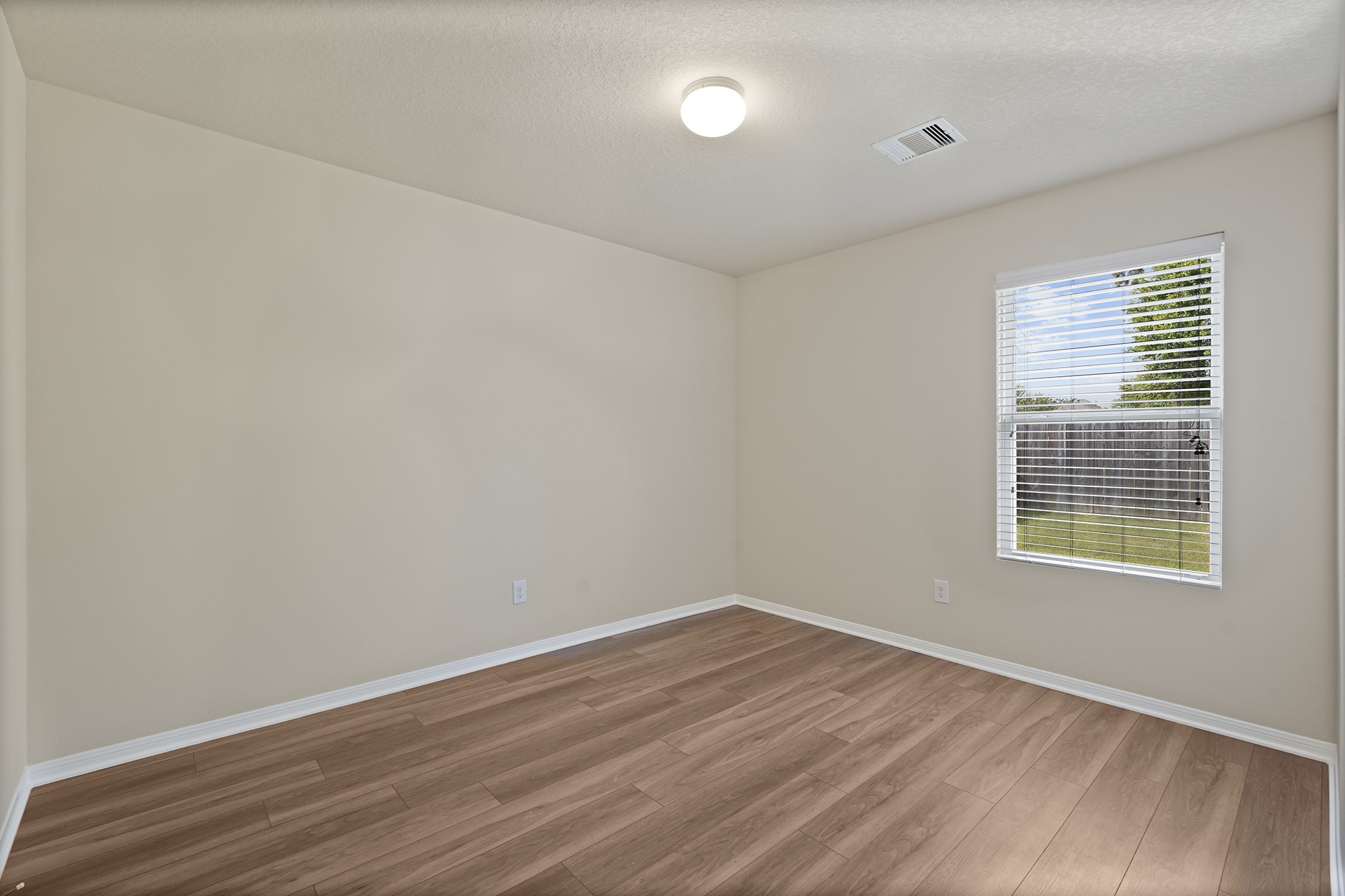 29417 Forest Floor Lane Spring, TX 77386 - Photo 13 of 25 wooden floor in an empty room with a window