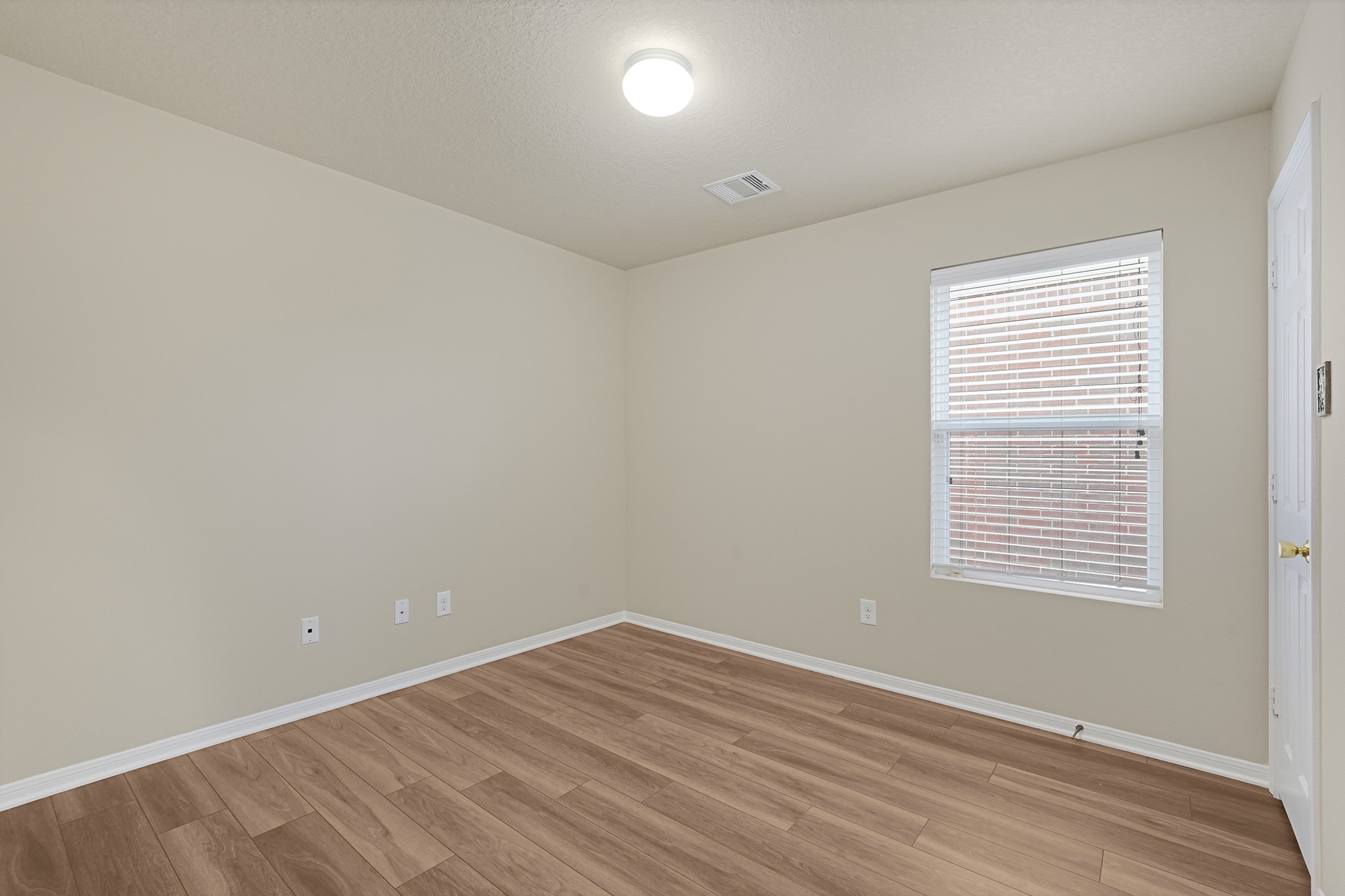 29417 Forest Floor Lane Spring, TX 77386 - Photo 14 of 25 a view of an empty room with wooden floor and a window