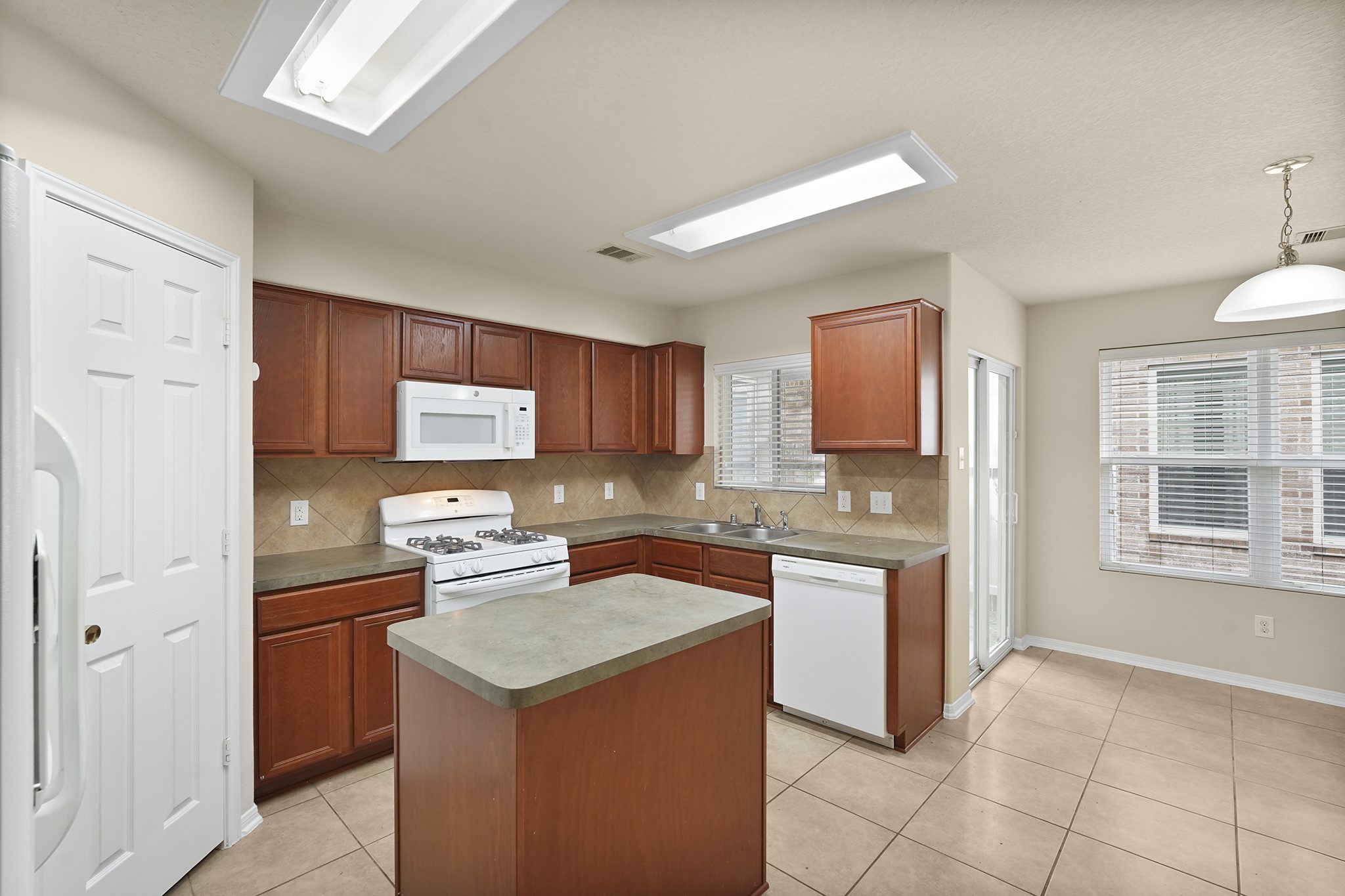 29417 Forest Floor Lane Spring, TX 77386 - Photo 8 of 25 a kitchen with a sink a stove and refrigerator