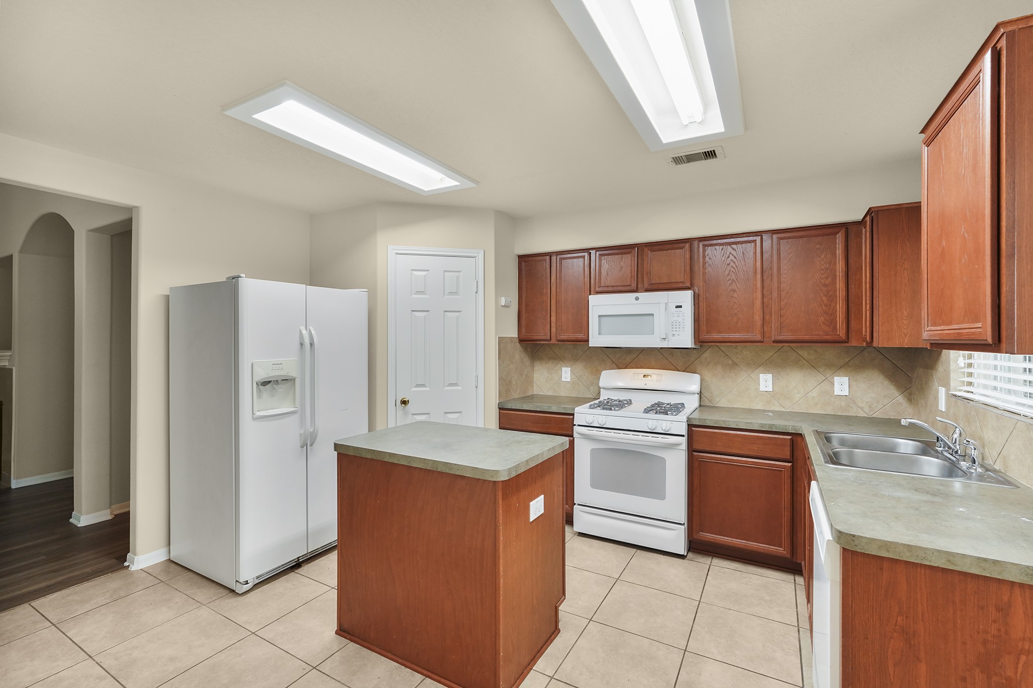 29417 Forest Floor Lane Spring, TX 77386 - Photo 9 of 25 a kitchen with stainless steel appliances granite countertop a refrigerator and a stove